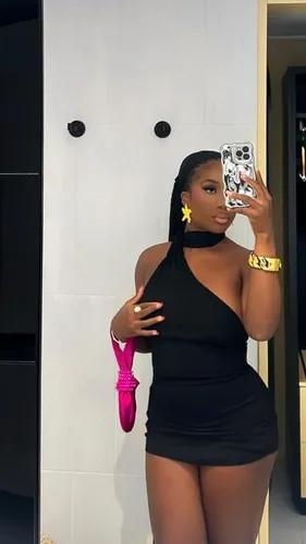 Try on a sleek braided hairstyle as seen on the woman in the image, who is taking a selfie in a mirror.