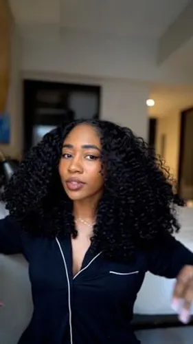 Try on a hairstyle featuring long, voluminous curls that frame the face beautifully.