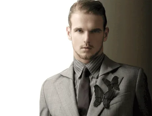 Try on this slicked back hairstyle for a polished look. The hair is neatly combed back to enhance the sleek appearance.