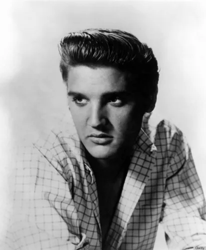 Try on a slicked-back quiff hairstyle, voluminous on top with a neatly styled appearance, great for a classic, sophisticated look.