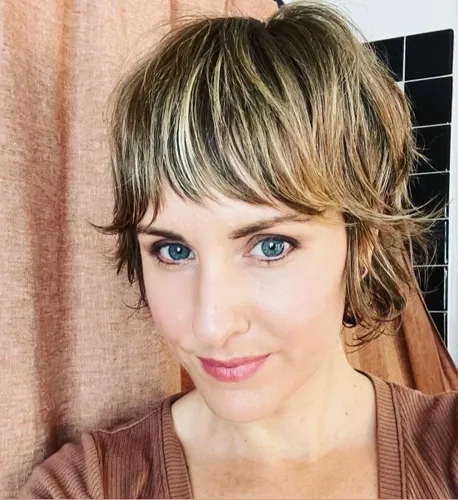 Try on this charming short wavy hairstyle with bangs. The bangs add a youthful and fresh look, while the gentle waves provide texture.