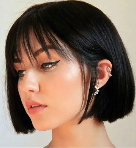 Try on a chic bob cut with straight bangs, neatly styled for a sleek look.