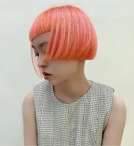 Try on this stylish short bob cut hairstyle with striking pink color, showcased from a sideways perspective. The hair texture appears soft and the cut neatly frames the head.
