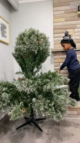 Try on a black beanie hat over braided hair, as seen on a child by the Christmas tree