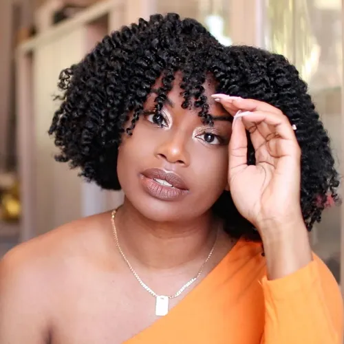 Try on this medium-length curly hairstyle featuring tight, shiny curls amply framing the face.