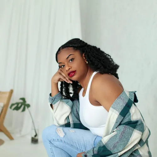 Try on this braided, long hairstyle showcased by the woman in the image.
