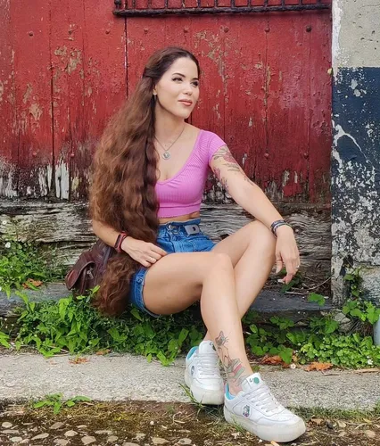 Try on this long, wavy hairstyle cascading over the shoulders, prominently brown with highlights, creating a flowing, voluminous appearance.