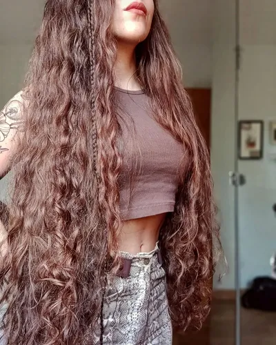 Try on this long, wavy hairstyle cascading down the shoulders, offering a voluminous and textured look.