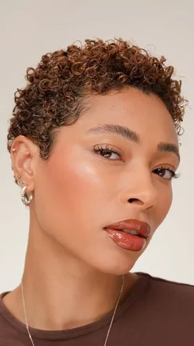 Try on a trendy short curly hairstyle with natural highlights.