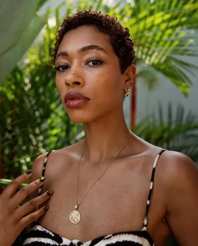 Try on this short curly hairstyle, neatly cropped with tight curls, offering a chic and effortless look.