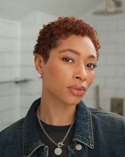 Try on a short curly hairstyle with tightly coiled curls, adding a vibrant and textured look.