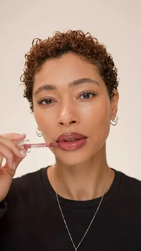 Try on a stylish short curly hairstyle, well-suited for showcasing tight curls that perfectly frame the face.