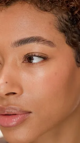 Try on this curly hairstyle, shown in a close-up image focusing on a partial face, emphasizing a brown curly hair texture.