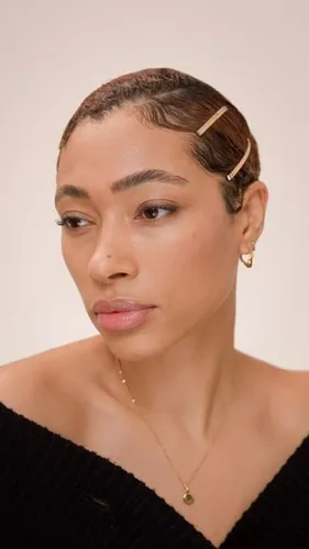 Try on a slicked back hairstyle with short hair, complemented by decorative hair clips.