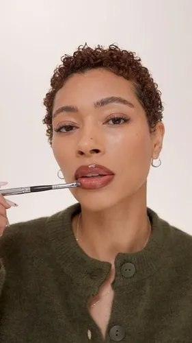 try on a curly hairstyle, with tightly coiled curls that add volume and texture.