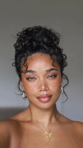 Try on this curly updo hairstyle featuring short, voluminous curls gathered at the top, adding a touch of elegance and freshness.