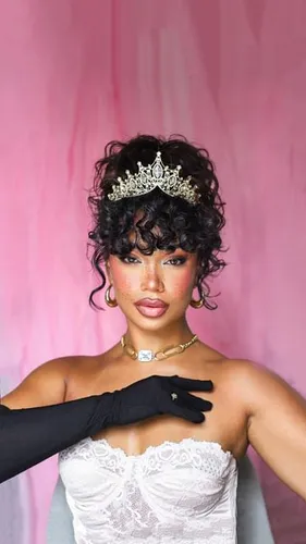 Try on a hairstyle featuring a curly updo adorned with a tiara, suitable for a formal event.
