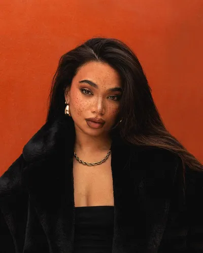 Try on this glamorous wavy long hairstyle, featuring a rich, natural dark hue, cascading elegantly around the face.