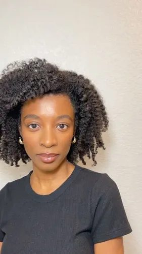 Try on this curly hairstyle, featuring defined, tightly coiled curls that add volume and textured appearance. Perfect for showcasing the natural beauty of curly hair.