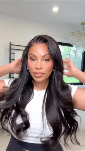 Try on this style featuring long black hair with soft, flowing waves. The hairstyle captures a look that is both voluminous and elegant.
