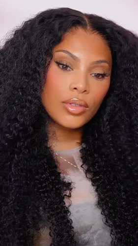 Try on this voluminous long curly hairstyle.