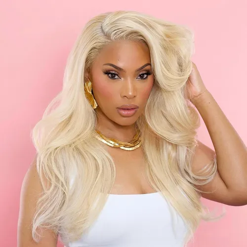 Try on this glamorous long blonde wavy hairstyle that frames the face beautifully, adding a touch of elegance and volume.