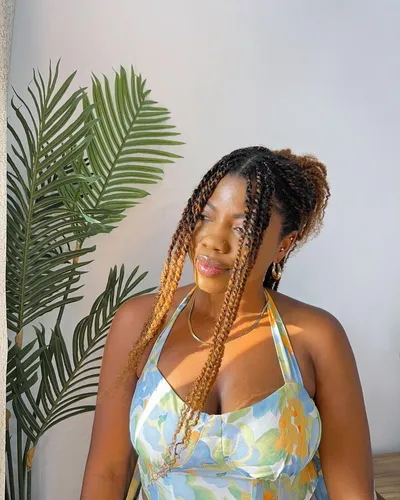 Try on this ombre braided hairstyle featuring long, twisted braids that transition from a dark root to a light blonde tip, stylishly paired with subtle accessories.