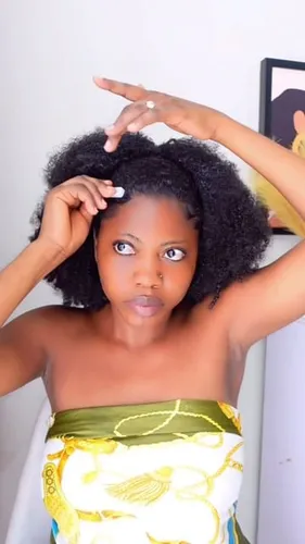 Try on this lively medium-length curly hairstyle captured on a woman who's playfully styling her hair.