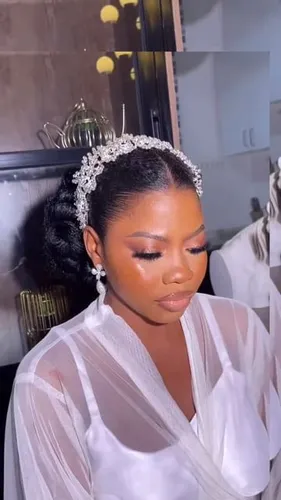 Try on this elegant braided bun hairstyle, embellished with a sparkling tiara for a regal look.