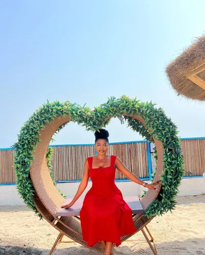 Try on this elegant updo hairstyle featuring tightly pulled back hair neatly styled at the top of the head, perfect for a formal or festive outdoor setting.