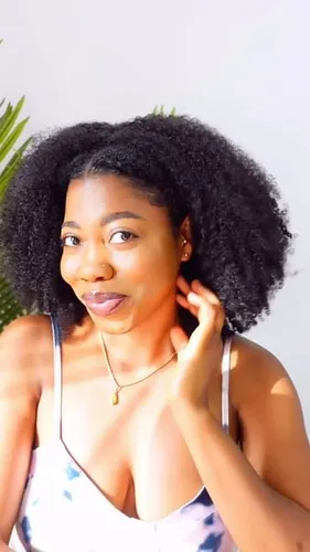 Try on this voluminous curly hairstyle, characterized by dense, springy curls adding a lively look.