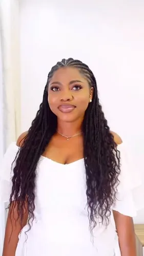 Try on a braided and long hairstyle with this example of a woman wearing her hair in loose, long braids that are slightly wavy at the ends.