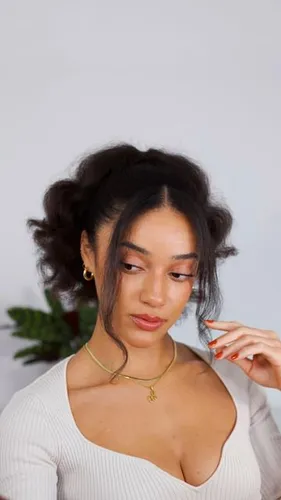 Try on a hairstyle featuring curly hair styled in a partial updo, with voluminous curls pinned up at the back and some loose strands adding a soft, casual appearance.