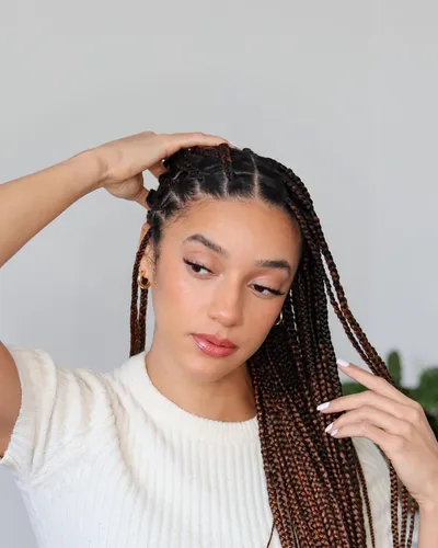 try on this sophisticated braided hairstyle with a mix of smaller and chunkier braids cascading down the sides