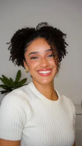 Try on this luscious medium-length curly hairstyle that frames the face beautifully.