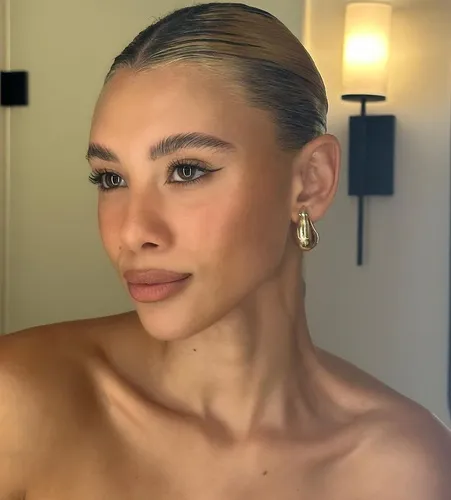 Try on this slicked back hairstyle that provides a neat and polished look, perfectly complementing a formal appearance.