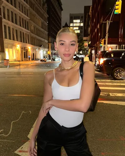 Try on a sleek, blonde, slicked-back hairstyle similar to the one showcased by the person in this picture.