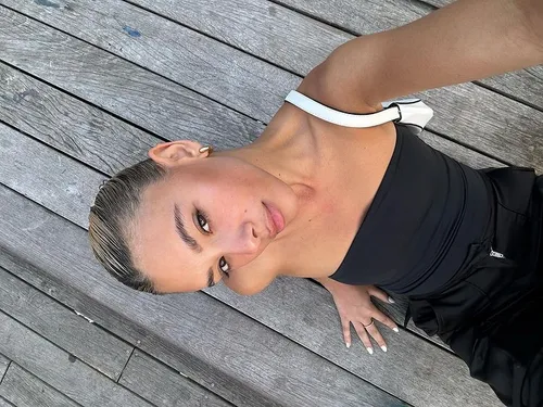 Try on this slicked back hairstyle in a tight bun that hugs the contours of the head for a clean, neat appearance.