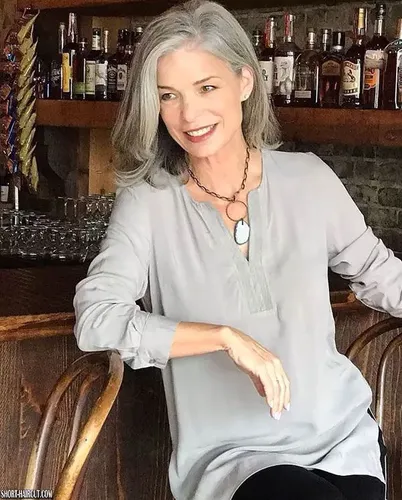 Try on a sophisticated and stylish medium-length gray hairstyle, showcased here as it gently frames the face, providing an elegant and graceful look.