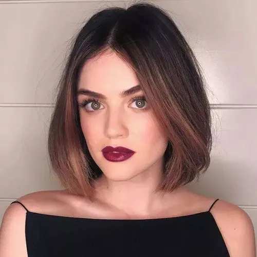 Try on a sleek bob hairstyle with ombre coloring transitioning from dark at the roots to lighter shades at the ends.