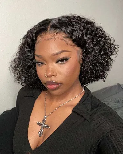 Try on this shoulder-length curly hairstyle, showing voluminous curls that frame the face beautifully.