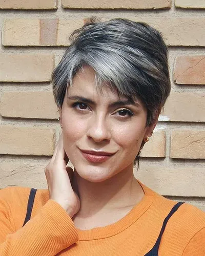 Try on a trendy short hairstyle featuring natural gray tones, elegantly styled with subtle layers for texture. Great for a sophisticated look.