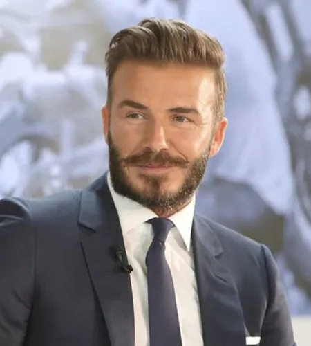 Try on a slicked back hairstyle. This elegant and polished style involves hair combed backward and neatly held in place, conveying a sharp, refined look. Often paired with a groomed beard, it exemplifies classic sophistication.