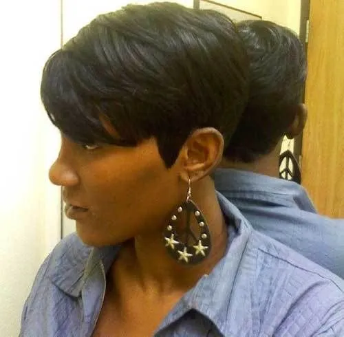 Try on this stylish pixie cut with short black hair, neatly tailored around the ears and back, adding a chic and modern vibe.