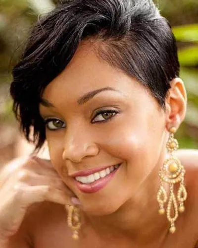 Try on a chic, short wavy hairstyle with side-swept bangs framing the face.