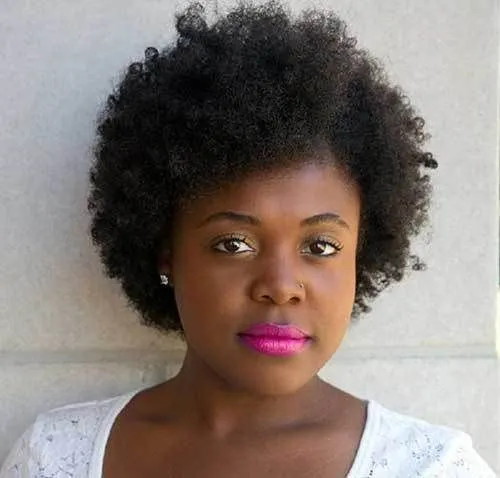 Try on this natural afro hairstyle, featuring voluminous and textured curls framing the face.