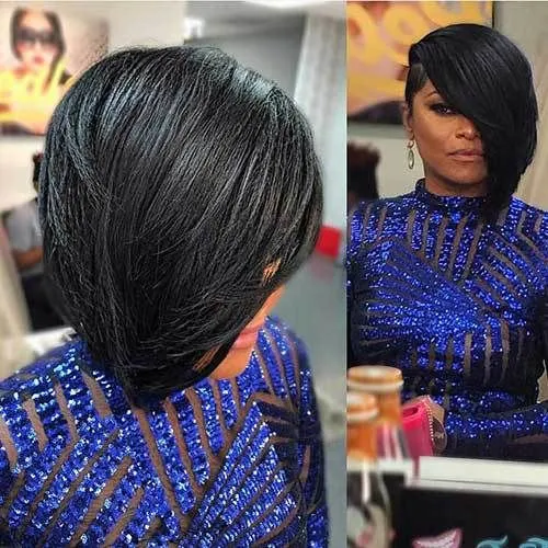 Try on this chic asymmetrical bob hairstyle with side-swept bangs, showcased by a woman dressed in a blue sequined dress.