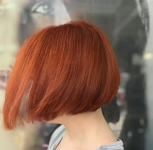 Try on this vibrant red bob cut hairstyle, featuring a smooth, even trim and a shiny, rich color, perfect for a bold and stylish look.