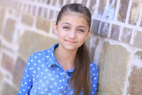 Try on a hairstyle similar to a young girl with a straight, long ponytail. The hair is neatly pulled back showcasing a simple yet elegant look.