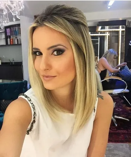 Try on this long, straight blonde hairstyle, perfect for a casual yet chic look.